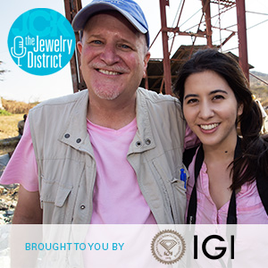 Father and daughter Richard and Billie Hughes, founders of Lotus Gemology, smiling outside with the Jewelry District and IGI logos